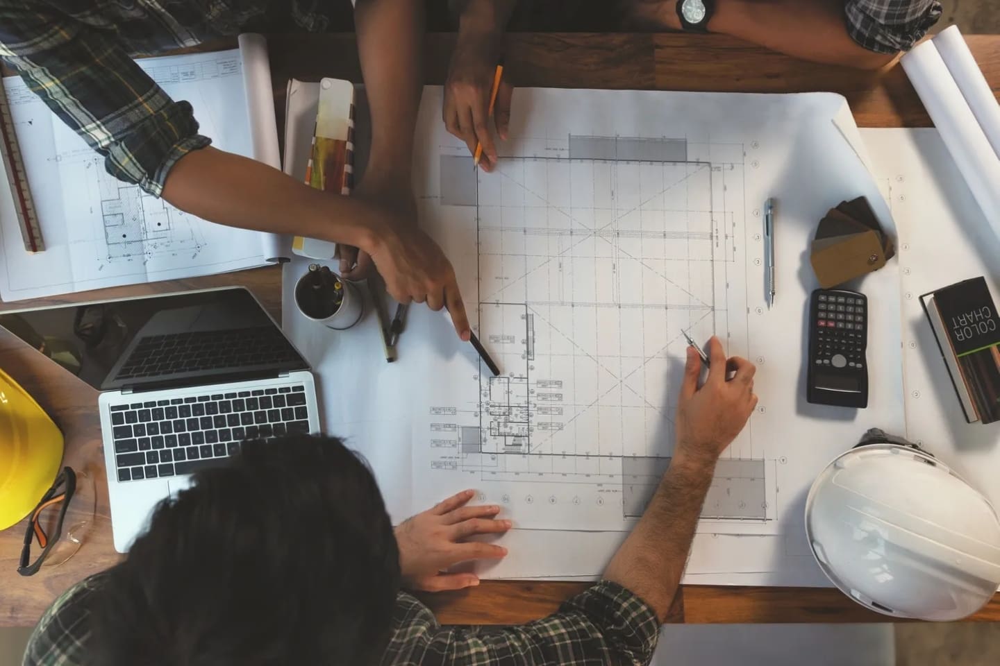 A group of people sitting around a table with papers.