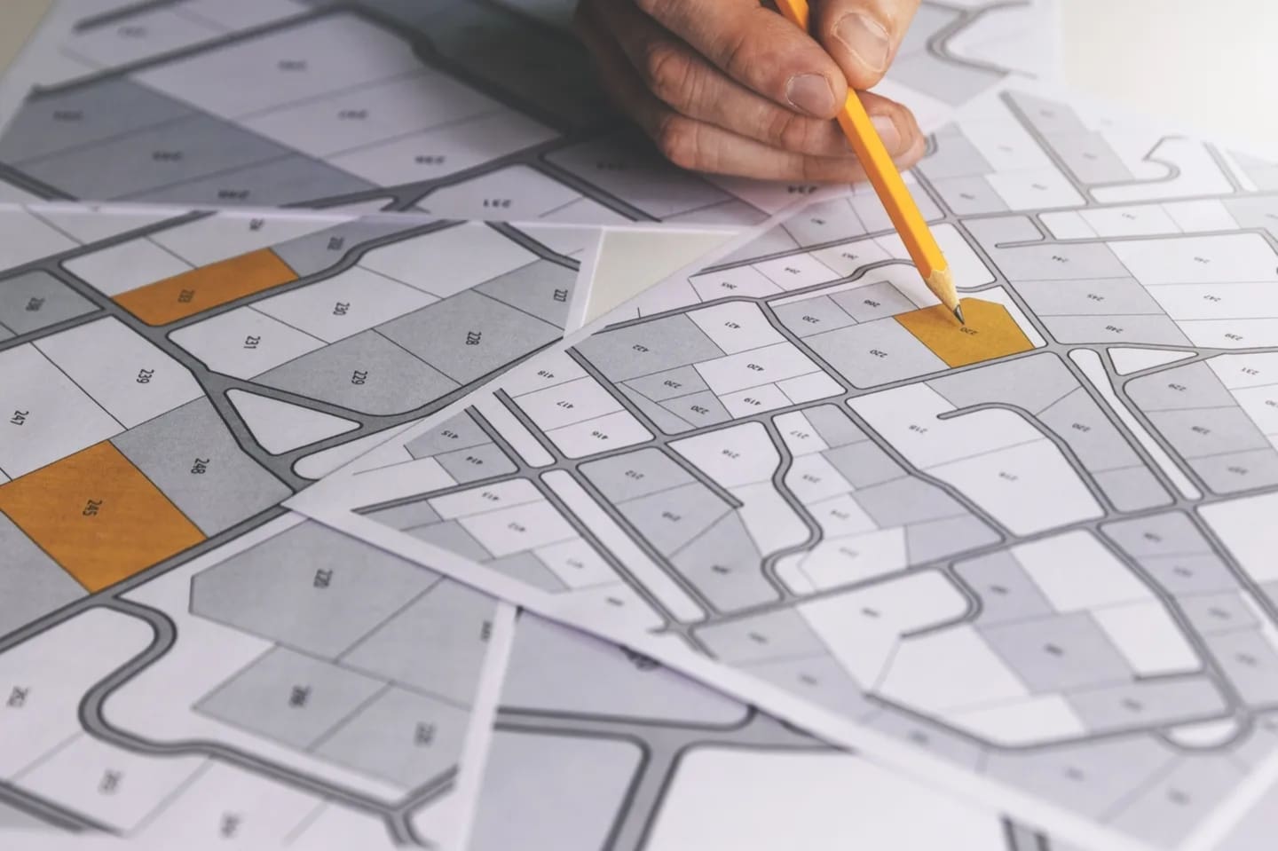 A person is drawing on the map of a city.