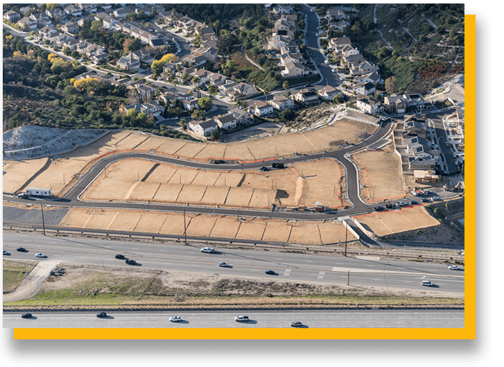 A large area of land with lots of cars driving down it.