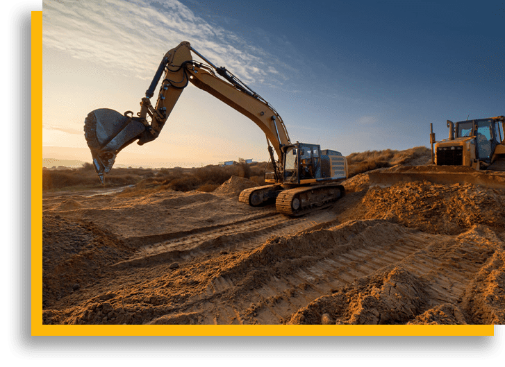 A large yellow and black excavator on top of dirt.