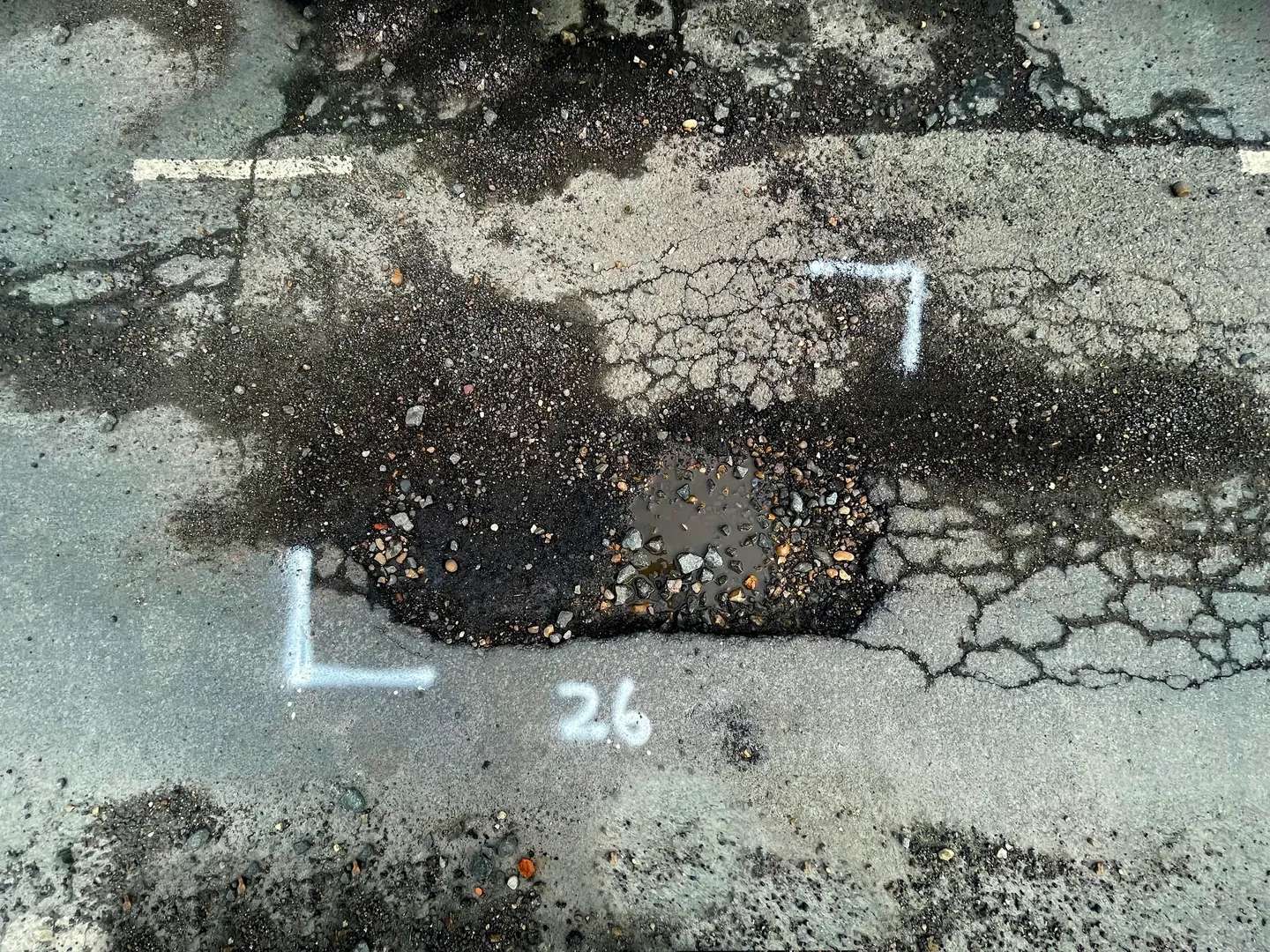 A number sign on the ground with some dirt